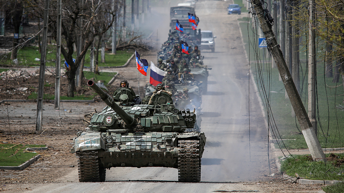 A convoy of pro-Russian troops moves along a road in Mariupol, Ukraine, on Thursday, April 21.