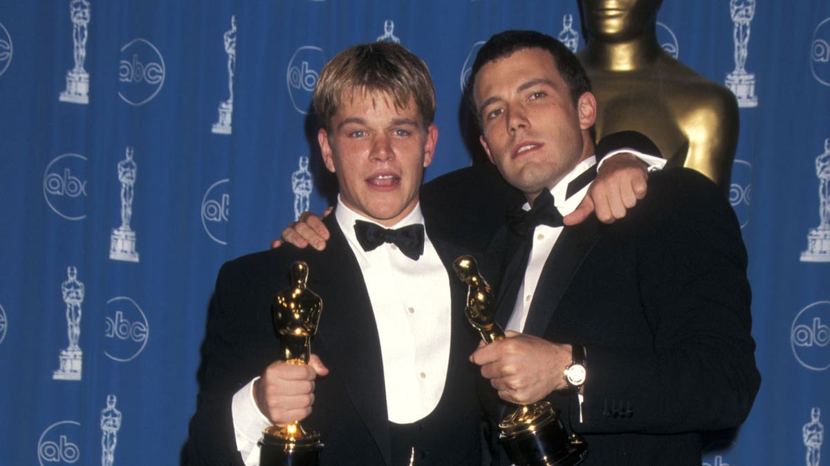 Ben Affleck and Matt Damon holding Oscar Awards