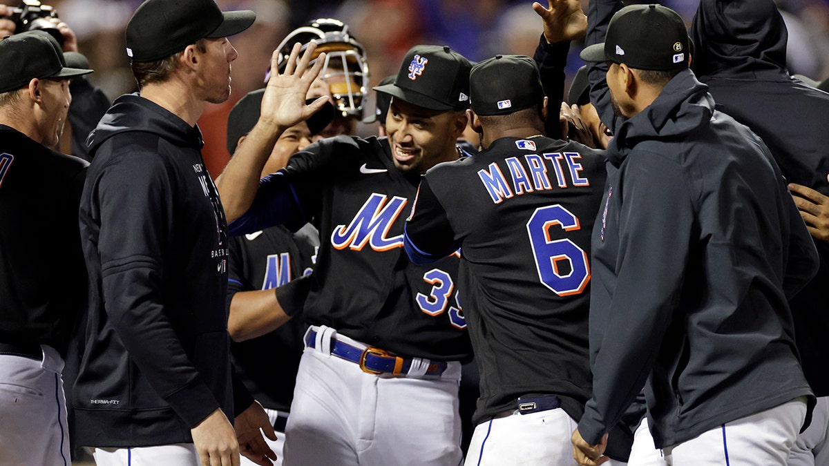 New York Mets pitcher Edwin Diaz (39) celebrates with teammates after a baseball game against the Philadelphia Phillies on Friday, April 29, 2022, in New York. The Mets won 3-0 on a combined no-hitter.