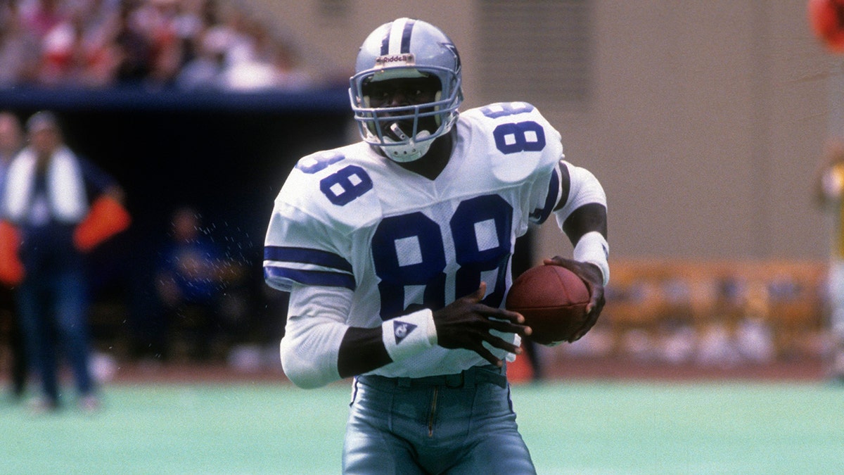 Wide Receiver Michael Irvin #88 of the Dallas Cowboys carries the ball against the New York Giants circa 1990 during an NFL football game at Giant Stadium in East Rutherford, New Jersey. Irvin played for the Cowboys from 1988-99.