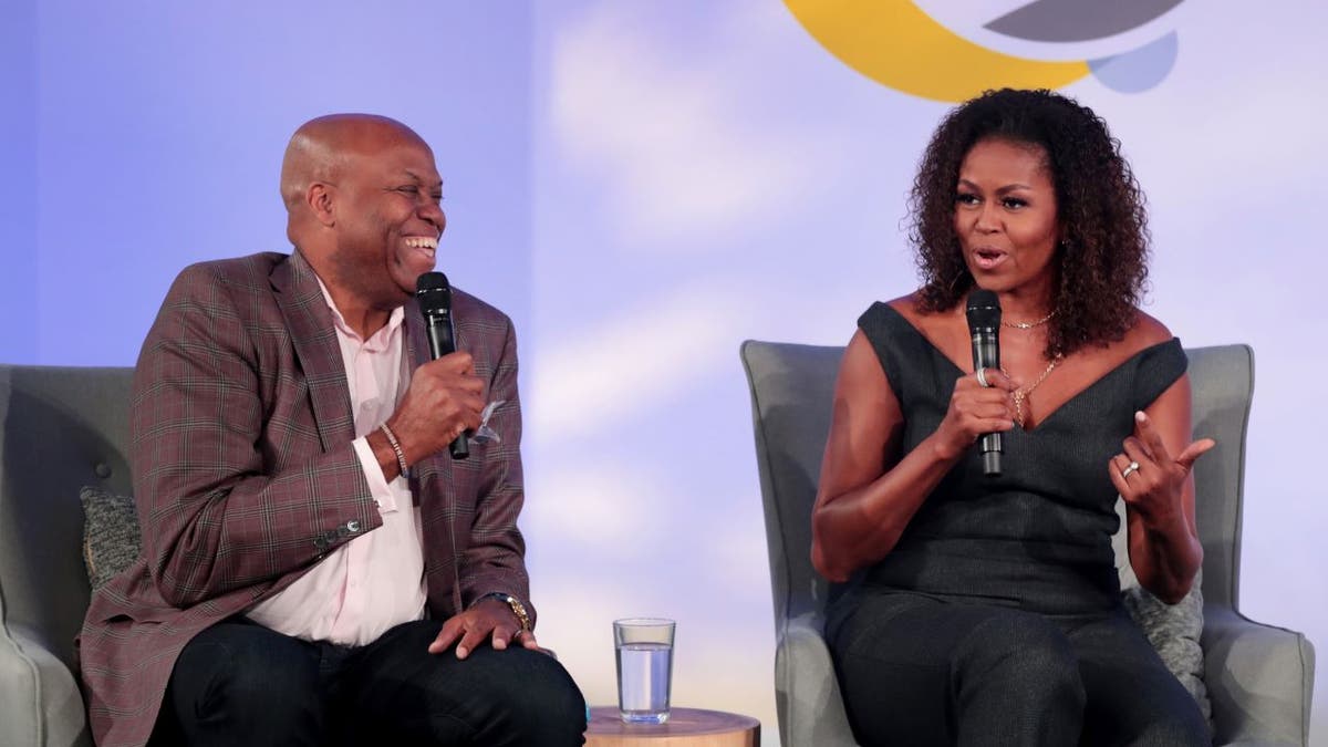 Former first lady Michelle Obama and her brother Craig Robinson speak to guests at the Obama Foundation Summit (Photo by Scott Olson/Getty Images)