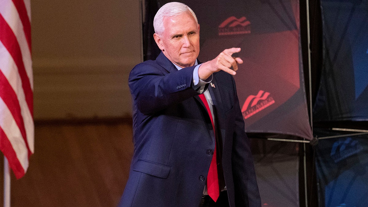 Former Vice President Mike Pence points as he arrives to speak at a campus lecture hosted by Young Americans for Freedom at the University of Virginia in Charlottesville, Virginia, on April 12, 2022. (Photo by RYAN M. KELLY/AFP via Getty Images)
