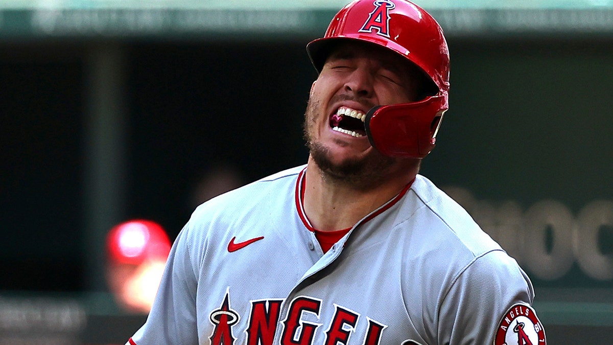 Los Angeles Angels' Mike Trout (27) reacts after being hit by a pitch in the fifth inning against the Texas Rangers of a baseball game on Sunday, April 17, 2022, in Arlington, Texas. 