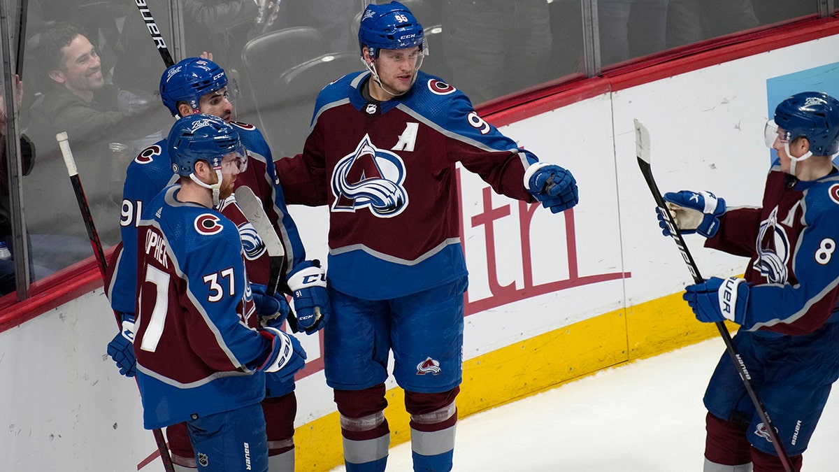 Colorado Avalanche right wing Mikko Rantanen, second from right, celebrates his goal against the San Jose Sharks with J.T. Compher, center Nazem Kadri and defenseman Cale Makar, from left, during the third period of an NHL hockey game Thursday, March 31, 2022, in Denver.
