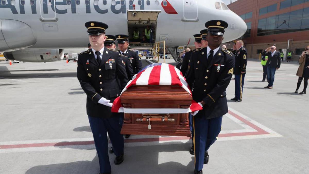 Honor Guard made up of members of the Utah National Guard conduct an Honorable Carry of Army Cpl. David B. Milano's remains at the Salt Lake City International Airport, April 26, 2022.