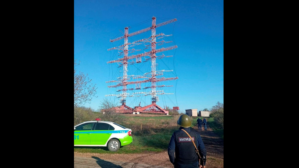 Authorities stand guard in front of radio antennas in Maiac following the blasts Tuesday.?