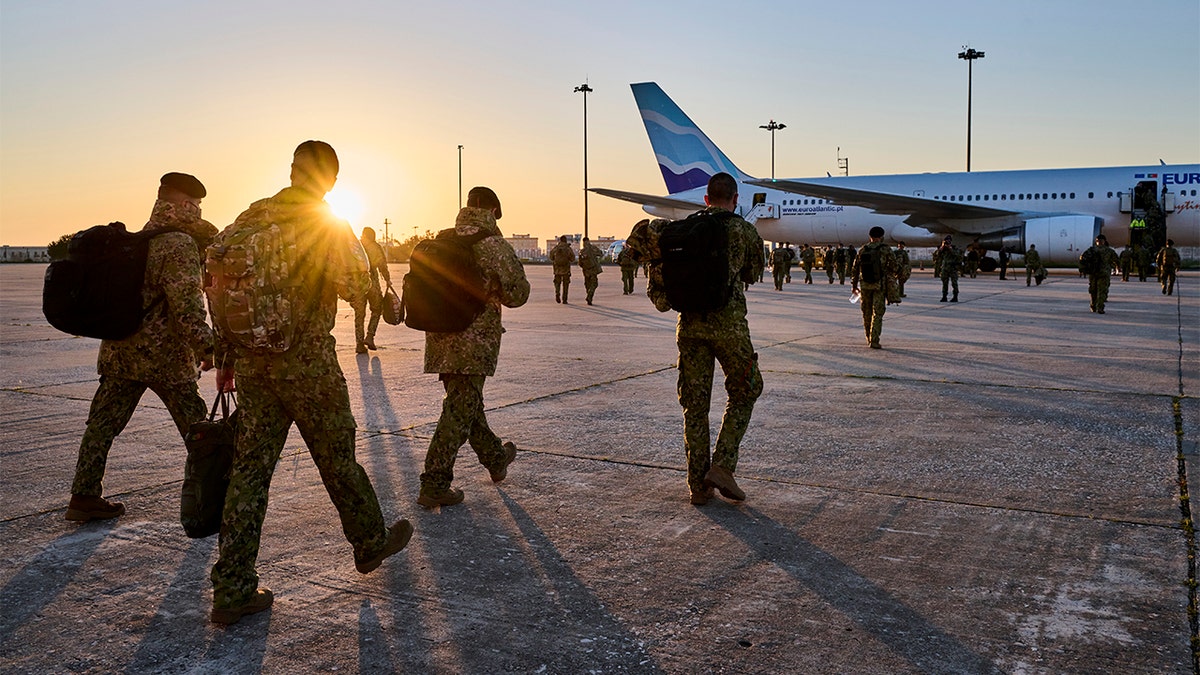 Portuguese military personnel embark at sunrise for deployment in Romania from Figo Maduro Military Airport on April 15, 2022 in Lisbon, Portugal. (Photo by Horacio Villalobos#Corbis/Corbis via Getty Images)