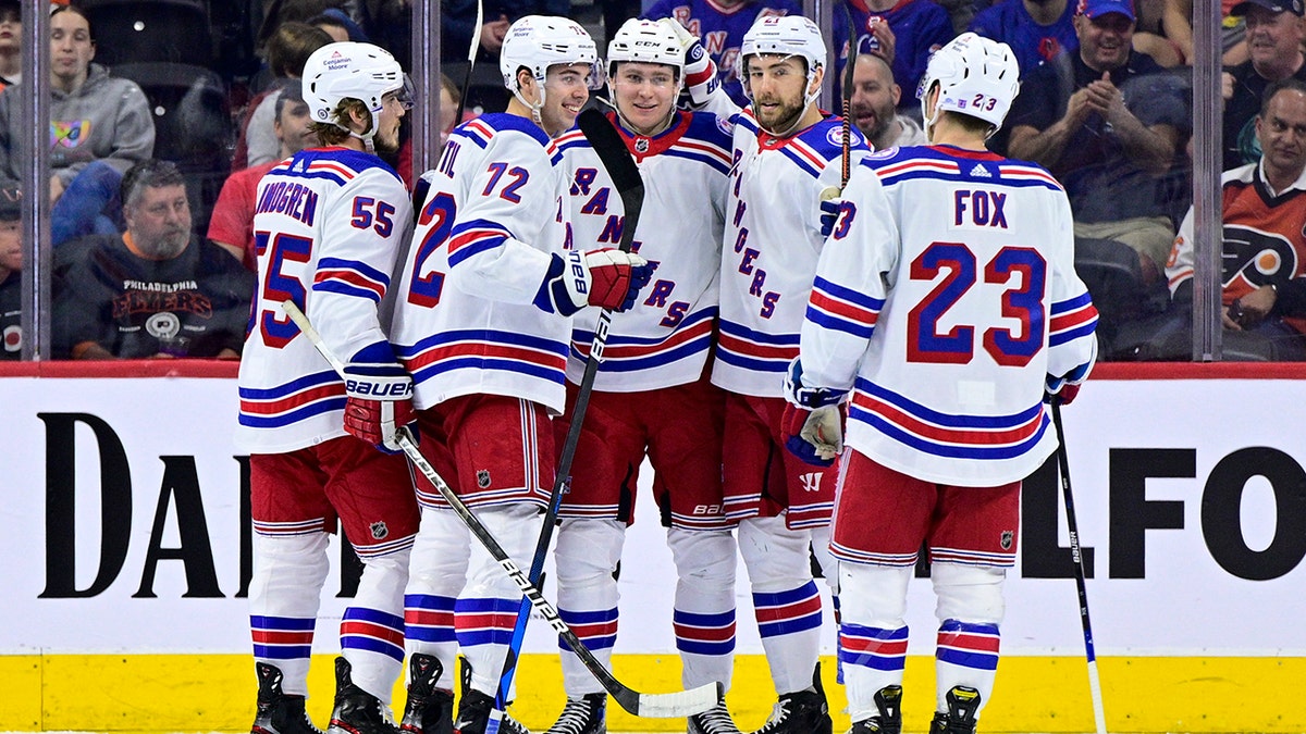 New York Rangers' Kaapo Kakko, center, celebrate his goal against the Philadelphia Flyers during the second period of an NHL hockey game, Wednesday, April 13, 2022, in Philadelphia.