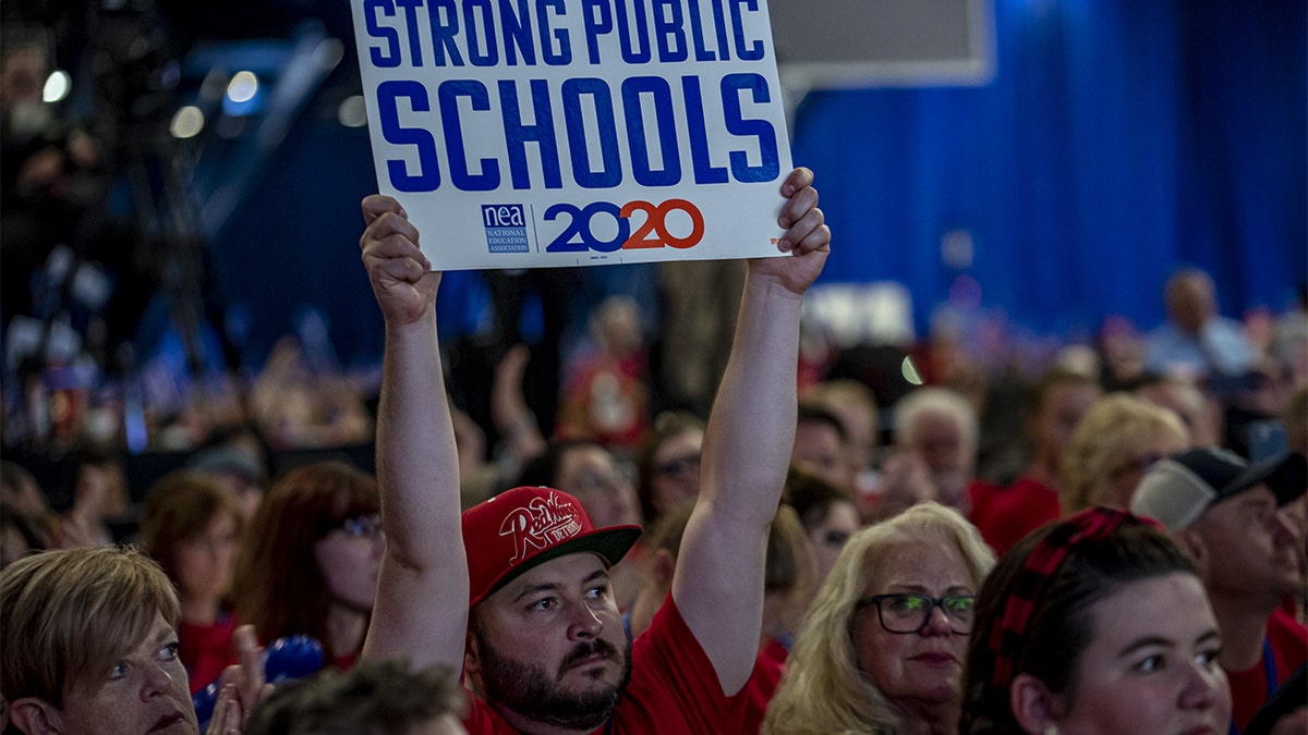 An attendee holds a sign that reads "Strong Public Schools 2020" during the National Education Association (NEA) #StrongPublicSchools Presidential Forum in Houston, July 5, 2019. (Sergio Flores/Bloomberg via Getty Images)