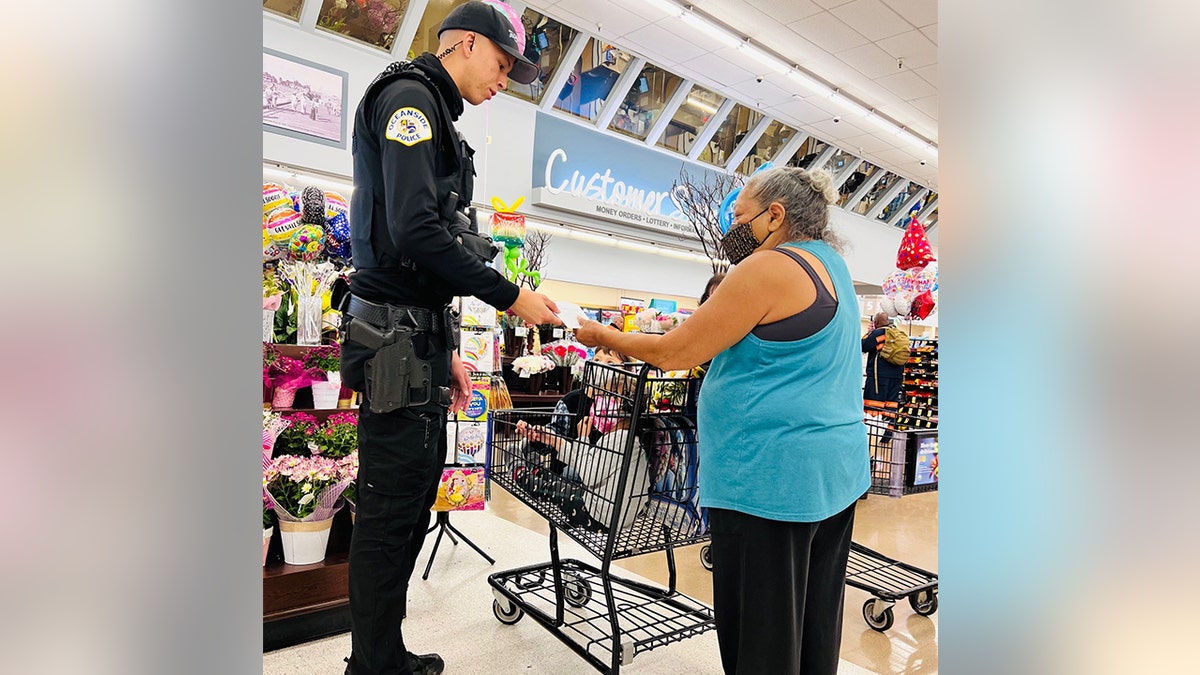 Oceanside Police officer gives grocery shoppers money