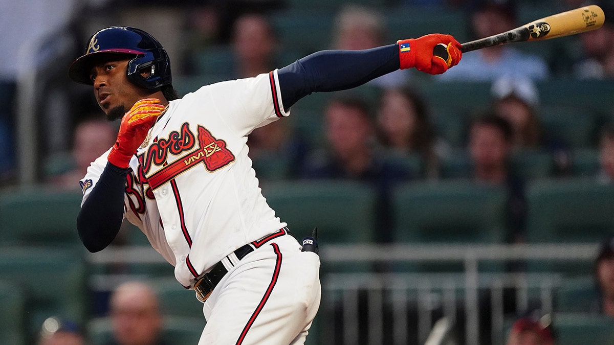Atlanta Braves' Ozzie Albies follows through on a two-run double during the second inning of the team's baseball game against the Washington Nationals on Tuesday, April 12, 2022, in Atlanta.?