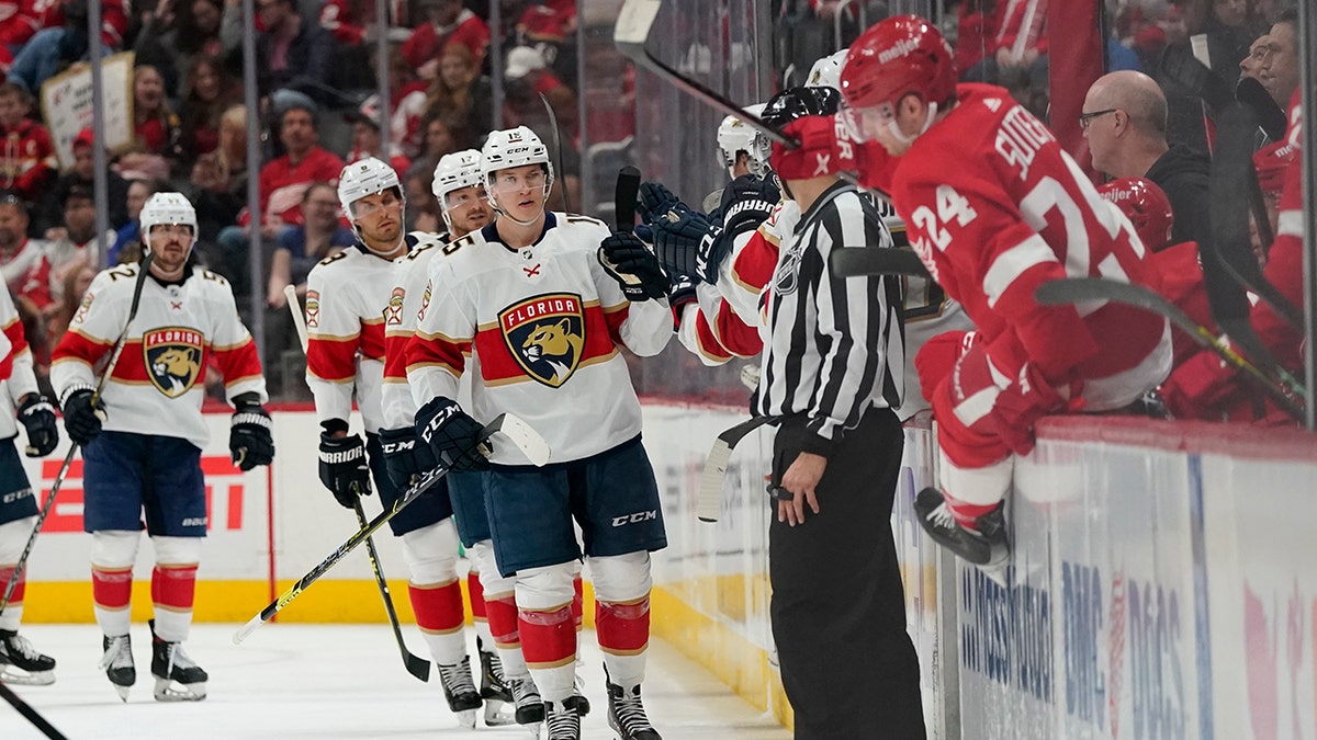 Florida Panthers center Anton Lundell greets teammates after scoring during the second period of an NHL hockey game against the Detroit Red Wings, Sunday, April 17, 2022, in Detroit.