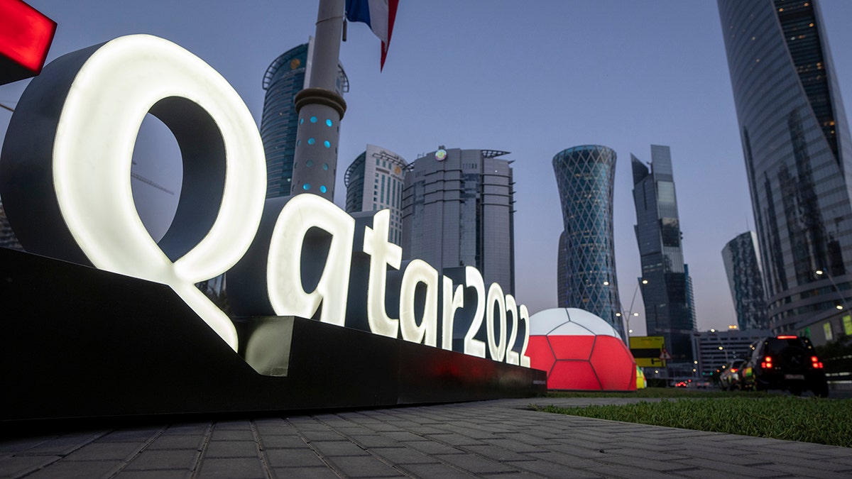 Branding is displayed near the Doha Exhibition and Convention Center where soccer World Cup draw will be held, in Doha, Qatar, Thursday, March 31, 2022. The final draw will be held on April 1.