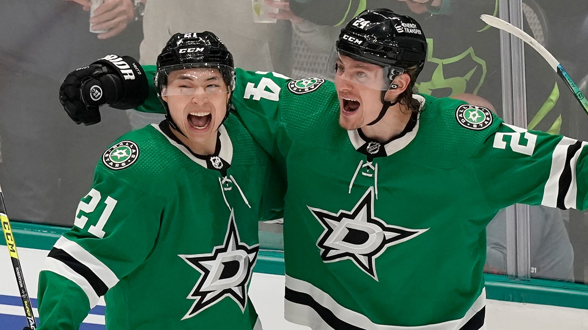 Dallas Stars center Roope Hintz (24) celebrates his goal with left wing Jason Robertson (21) during the third period of the team's NHL hockey game against the Tampa Bay Lightning in Dallas, Tuesday, April 12, 2022. The Stars won 1-0.
