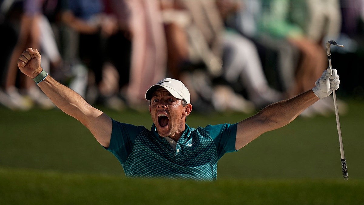 Rory McIlroy, of Northern Ireland, reacts after holing out from the bunker for a birdie during the final round at the Masters golf tournament on Sunday, April 10, 2022, in Augusta, Ga.