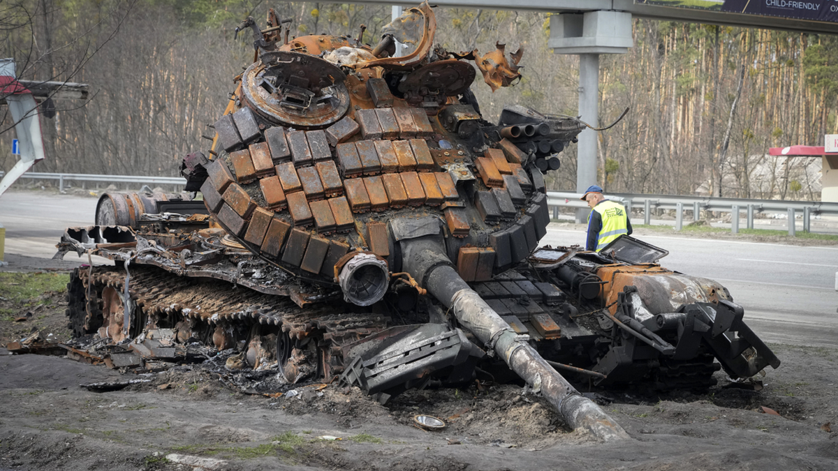 A damaged Russian tank is seen on a highway to Kyiv, Ukraine, on Monday.