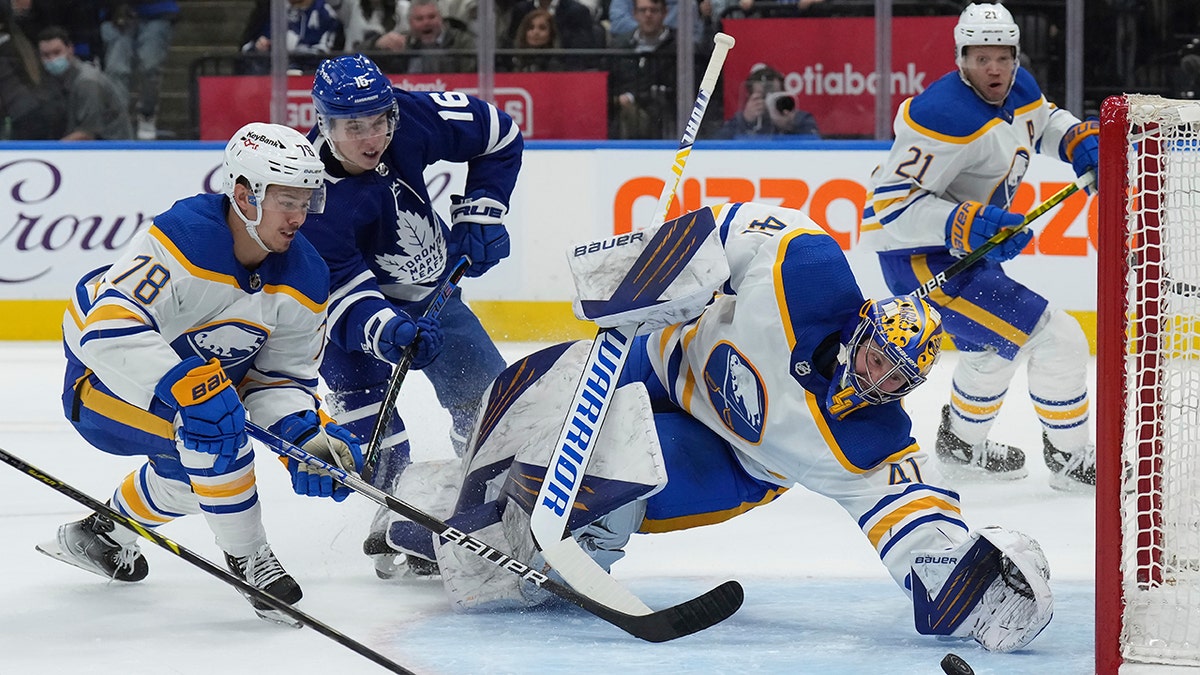 Buffalo Sabres goaltender Craig Anderson (41) makes a diving save as Toronto Maple Leafs forward Mitchell Marner (16) and Sabres defenseman Jacob Bryson (78) look for a possible rebound during the second period of an NHL hockey game Tuesday, April 12, 2022, in Toronto.