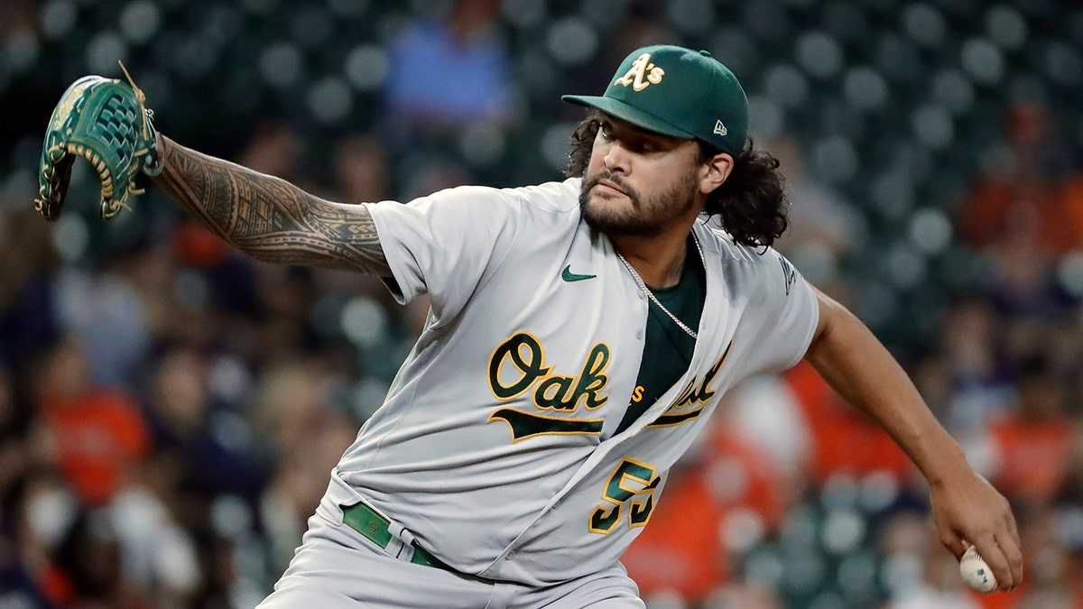 FILE - Oakland Athletics starting pitcher Sean Manaea throws against the Houston Astros during the first inning of a baseball game, Oct. 1, 2021, in Houston. The San Diego Padres bolstered their rotation on Sunday, April 3, 2022, acquiring left-hander Manaea in a trade with the Athletics.