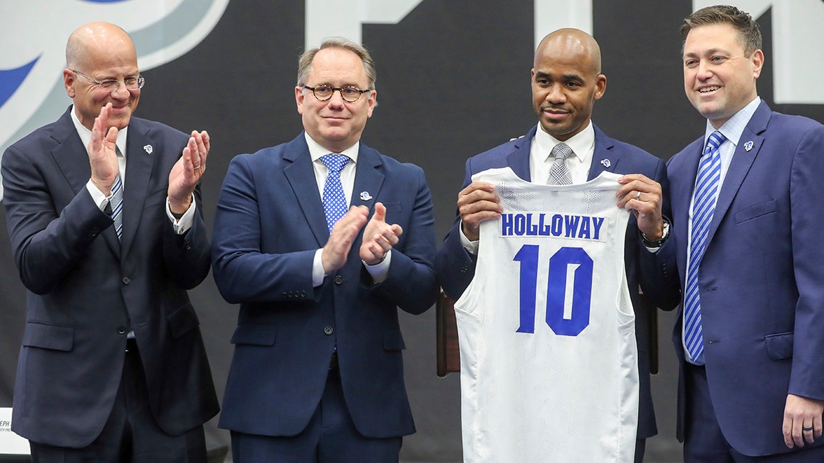 Kevin Marino, chair of the Seton Hall University Board of Regents, from left, Seton Hall President Joseph E. Nyre, new men's basketball coach Shaheen Holloway and SHU Athletic Director Bryan Felt, attend the introductory news conference for Holloway at Walsh Gym on Thursday, March 31, 2022, in South Orange, N.J.