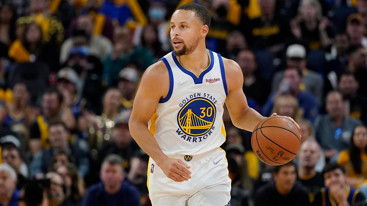 Golden State Warriors guard Stephen Curry dribbles the ball up the court against the Denver Nuggets during the second half of Game 2 of an NBA basketball first-round playoff series in San Francisco, Monday, April 18, 2022.