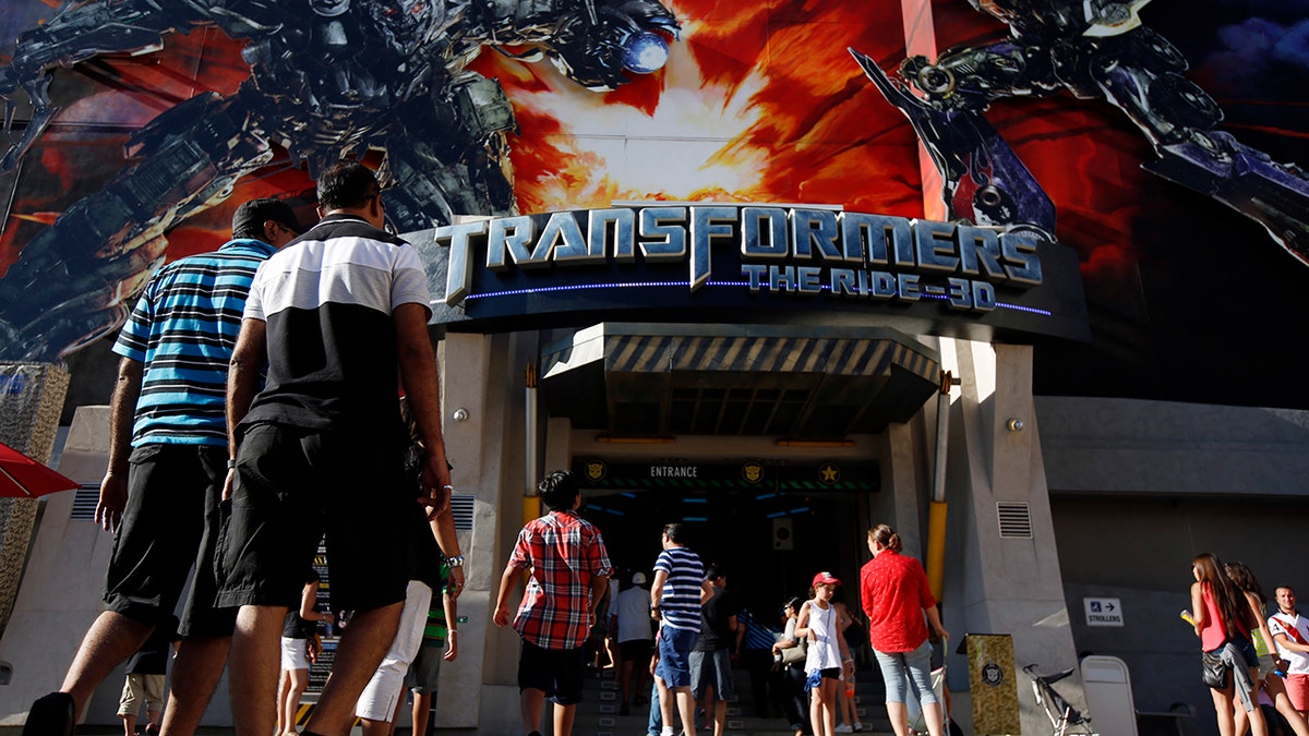 Visitors enter "Transformers: The Ride-3D" at the Universal Studios Hollywood theme park in Hollywood, California, U.S., on Thursday, Aug. 15, 2013.