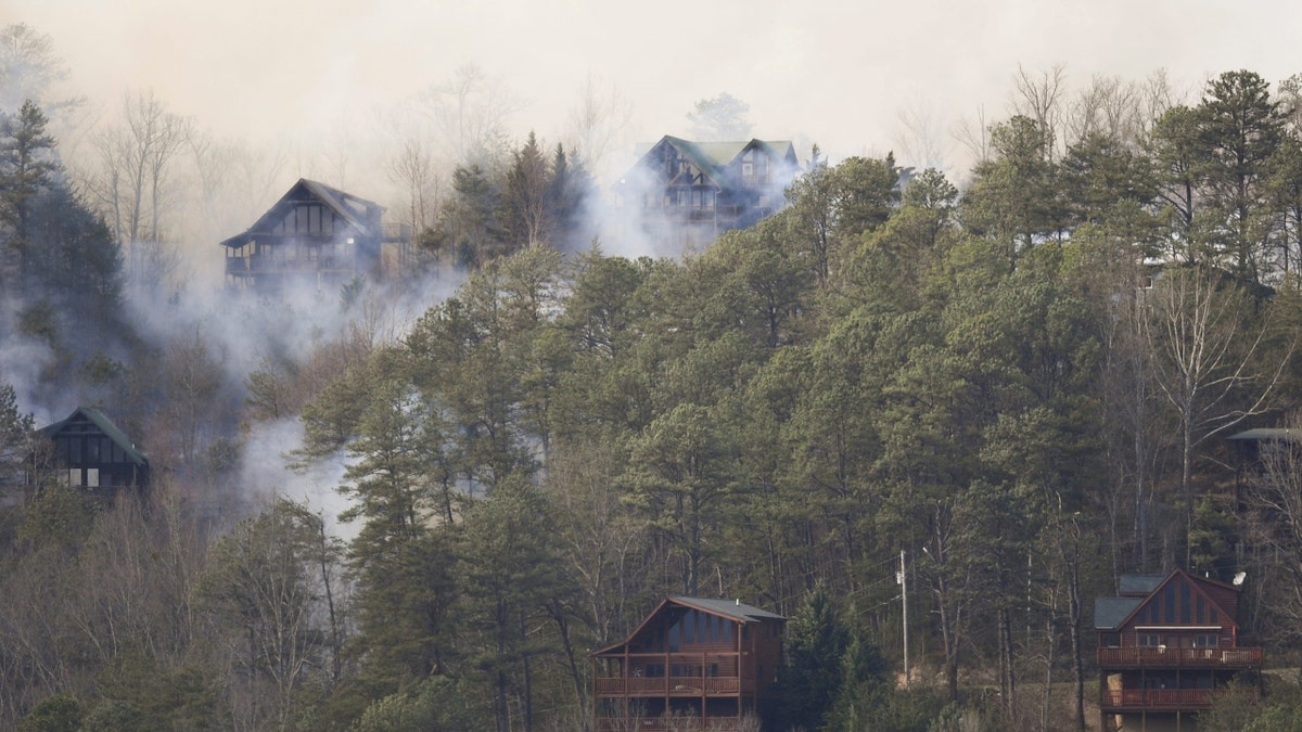 Smoke from the Wears Valley wildfire surrounds cabins in Seiverville, Tennessee.