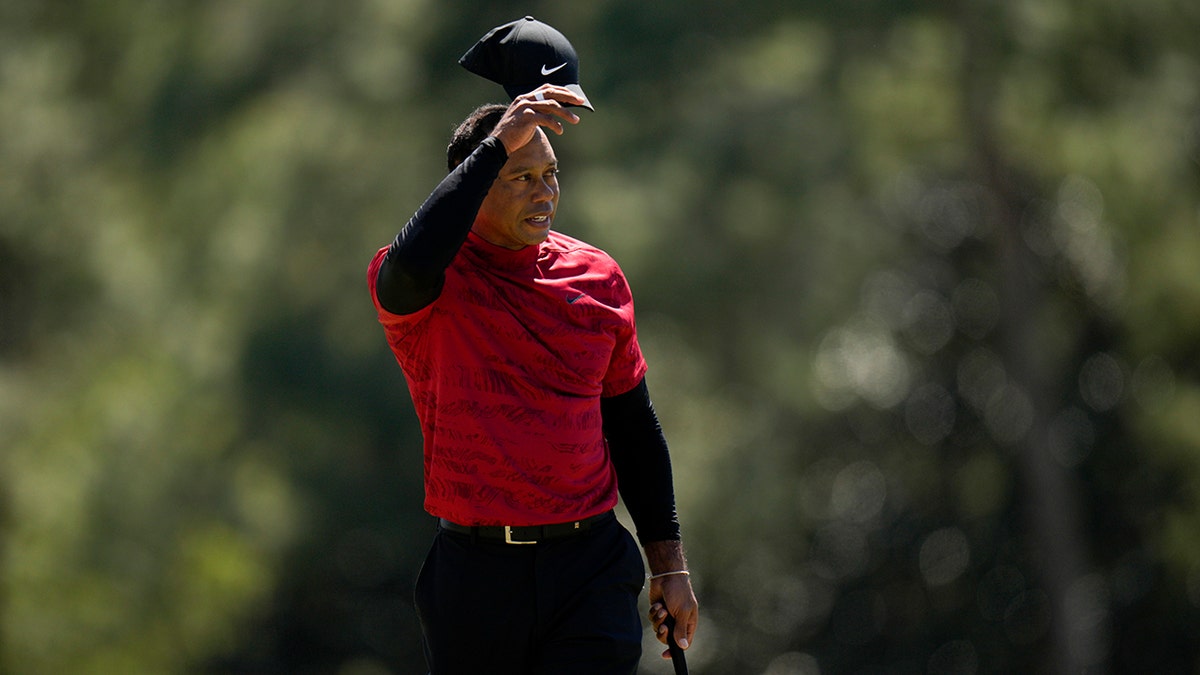 Tiger Woods tips his cap on the 18th hole during the final round at the Masters golf tournament on Sunday, April 10, 2022, in Augusta, Ga. 