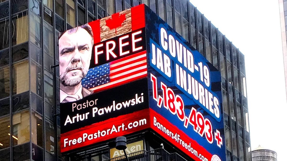A sign in Times Square calls for Pastor Artur Pawlowski's freedom in New York City, New York.