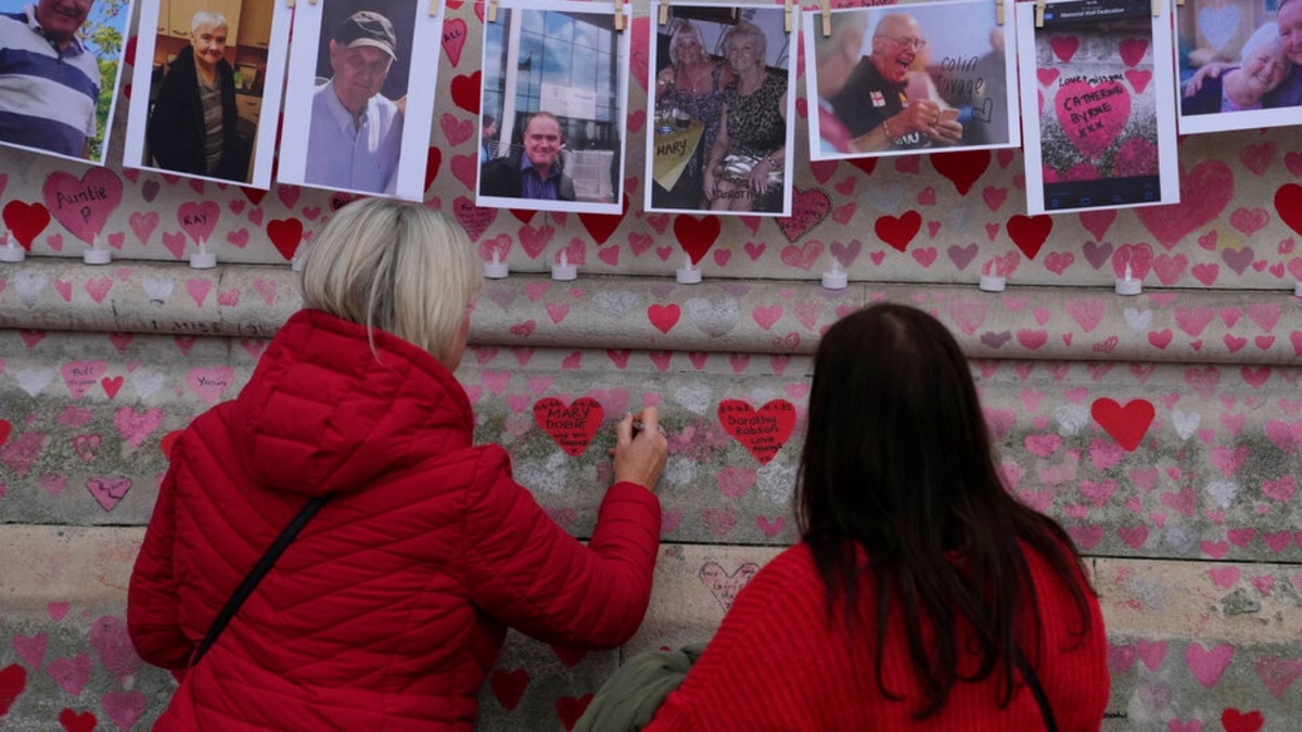 Family members write a message to sisters who died of COVID-19 in London.