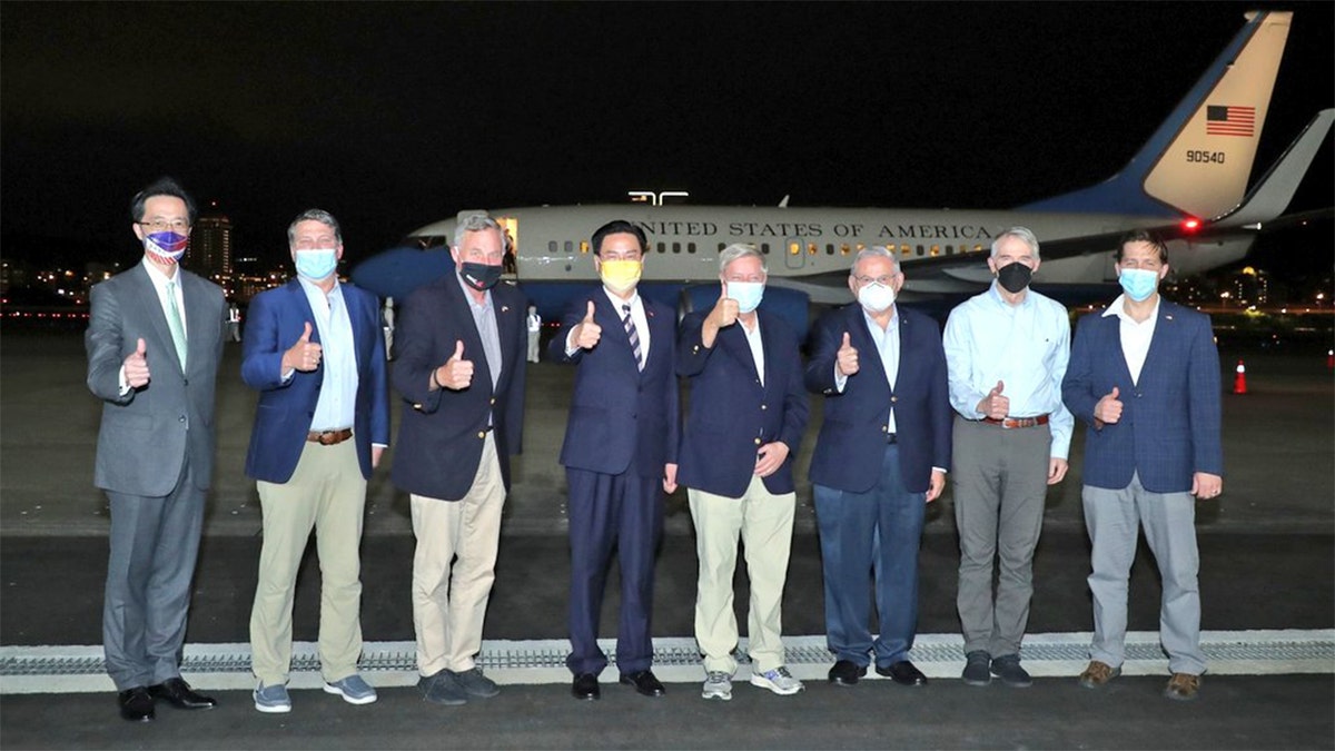 US Senators outside airplane