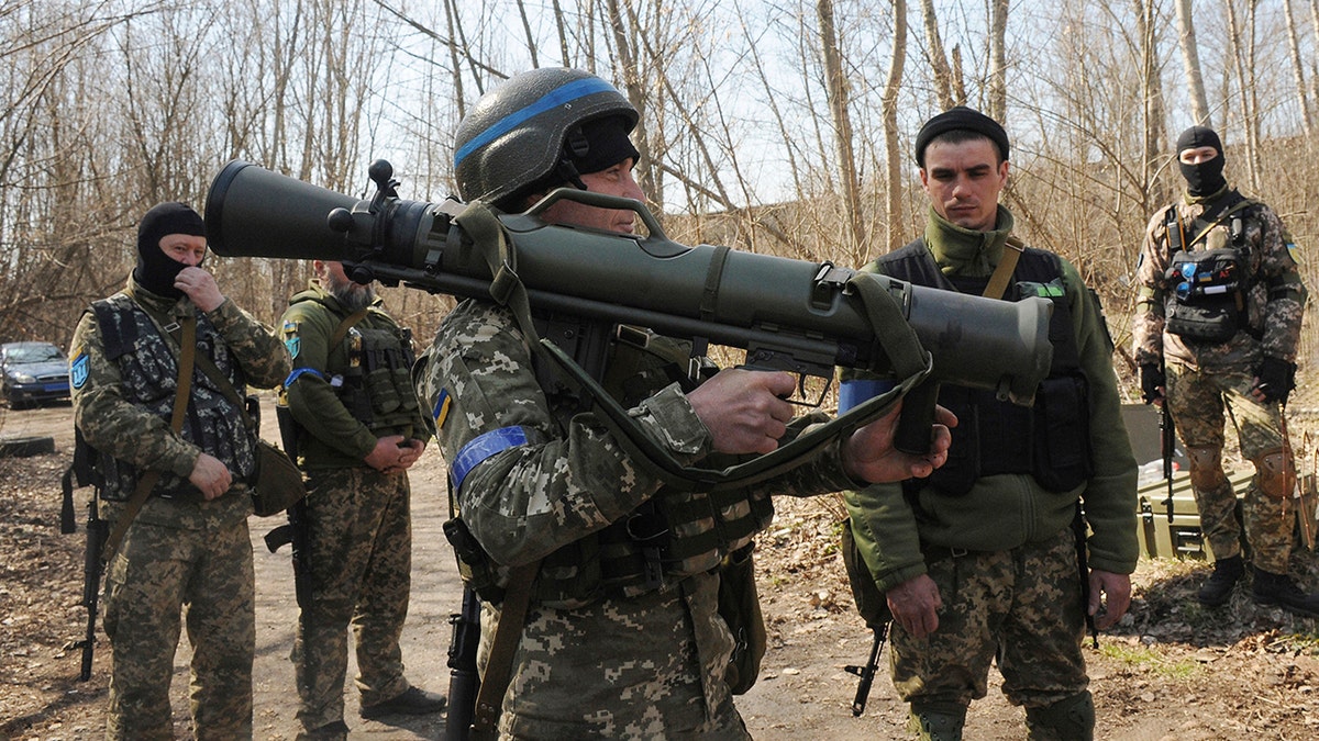 FILE - Ukrainian servicemen study a Sweden shoulder-launched weapon system Carl Gustaf M4 during a training session on the near Kharkiv, Ukraine, April 7, 2022. (AP Photo/Andrew Marienko, File)