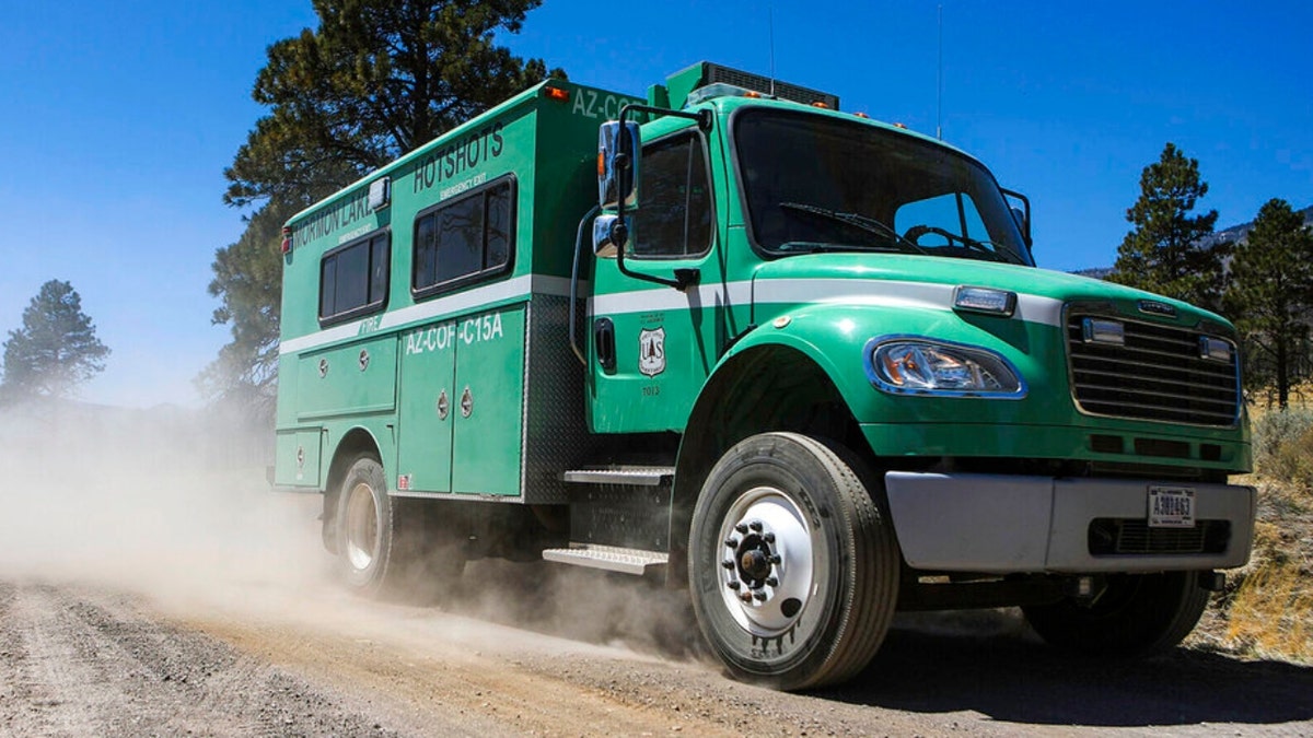 The Mormon Lake Hotshots drive down a forest road