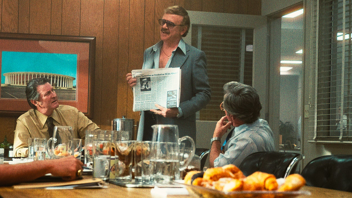 This image released by HBO shows Brett Cullen, portraying Bill Sharman, left, and John C. Reilly, portraying Jerry Buss, standing, in a scene from the series "Winning Time: The Rise of the Lakers Dynasty."