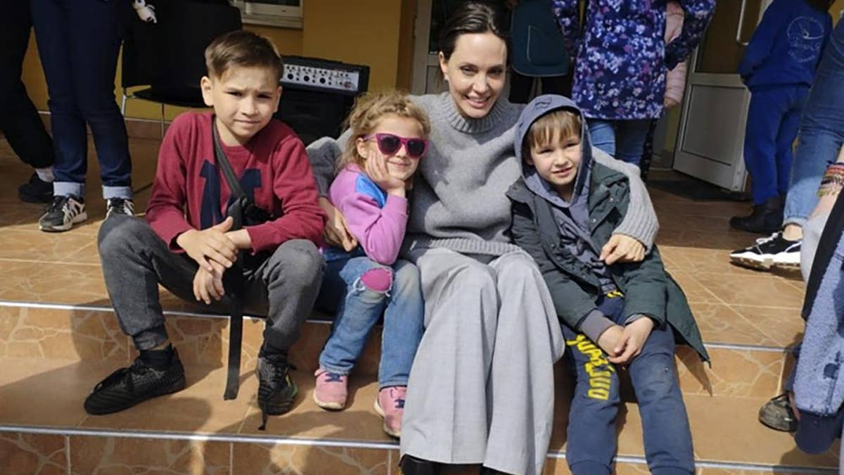 In this image provided by the Lviv city hall Angelina Jolie, Hollywood movie star and UNHCR goodwill ambassador, poses for photo with kids in Lviv, Ukraine, Saturday, Apr. 30, 2022.