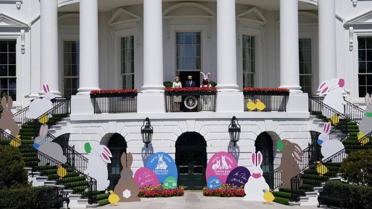 President Joe Biden appears with first lady Jill Biden and the Easter Bunny on the Blue Room balcony at the White House on April 5, 2021, in Washington.