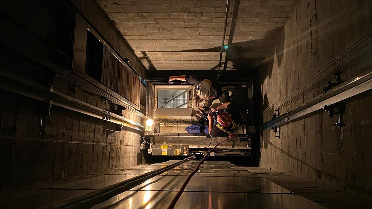 New Jersey firefighters rappelled down an elevator shaft to rescue six children on Friday when an industrial elevator they were inside got stuck between floors.