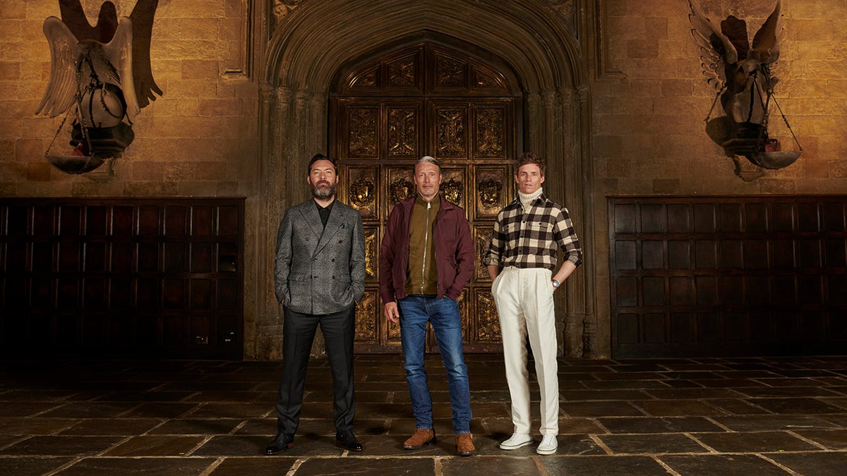 Jude Law, Mads Mikkelsen and Eddie Redmayne attend a photocall for "Fantastic Beasts: The Secrets of Dumbledore" in the Great Hall at Warner Bros. Studio Tour London on March 29, 2022 in London, England. 