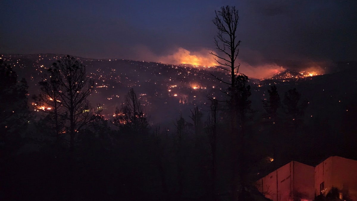Fire burns along a hillside in the Village of Ruidoso, N.M., on Wednesday, April 13, 2022. 
