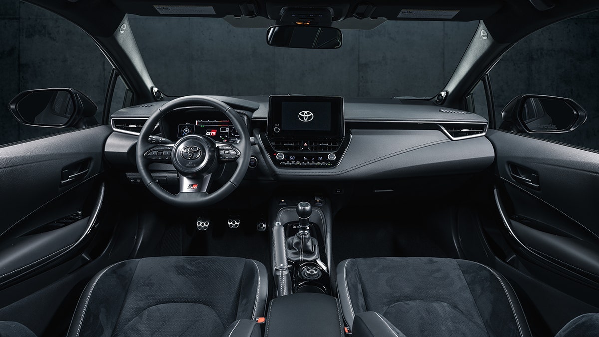 Sports seats and accents highlight the GR Corolla's interior.