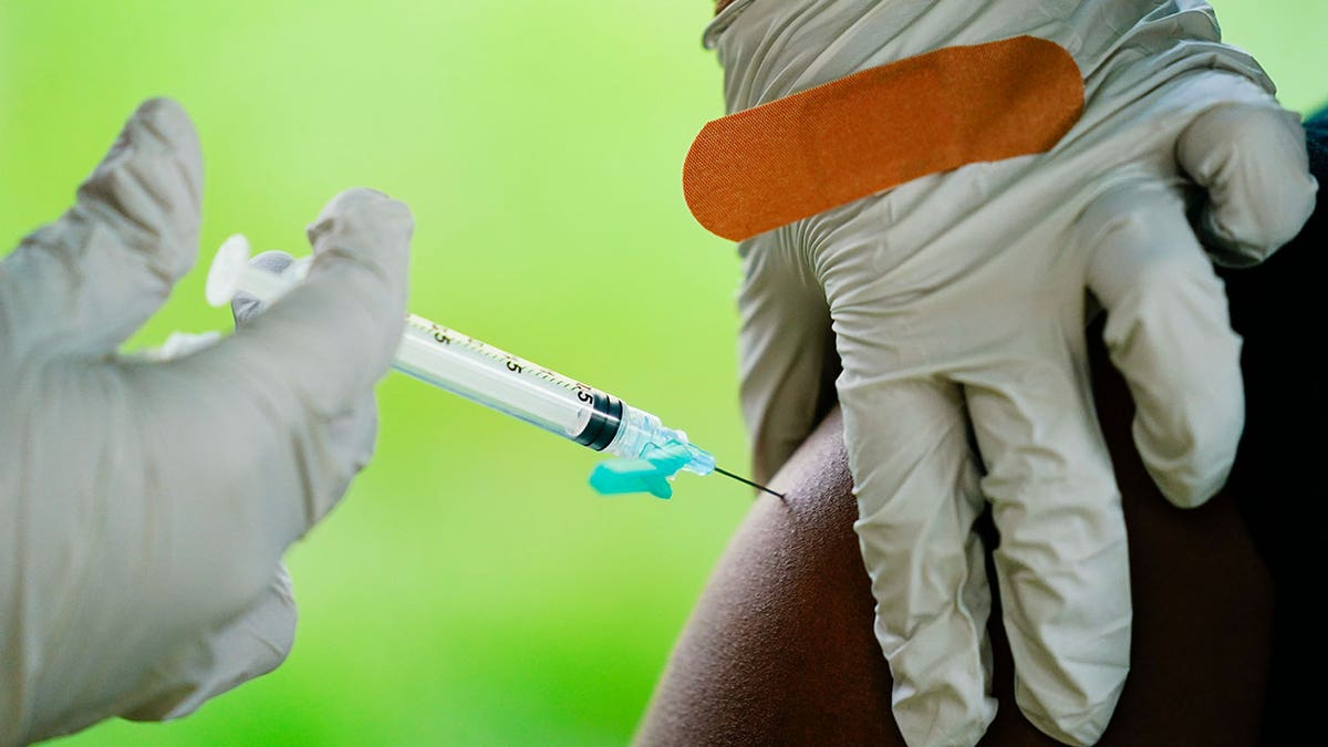 Healthcare worker administers Covid-19 vaccine