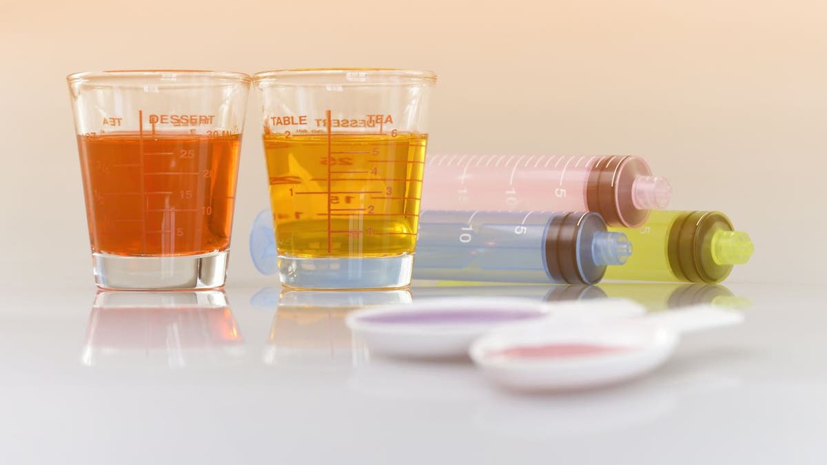 Two medicine cups, spoons and three oral syringes