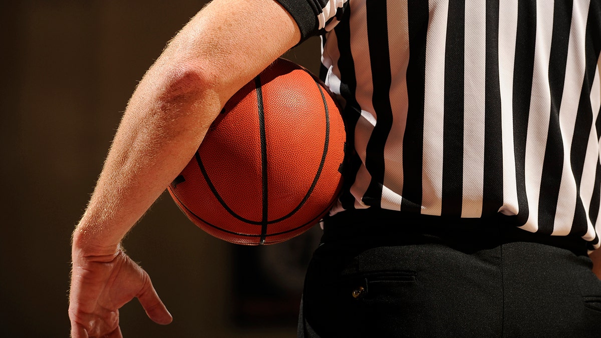 Ref holding basketball