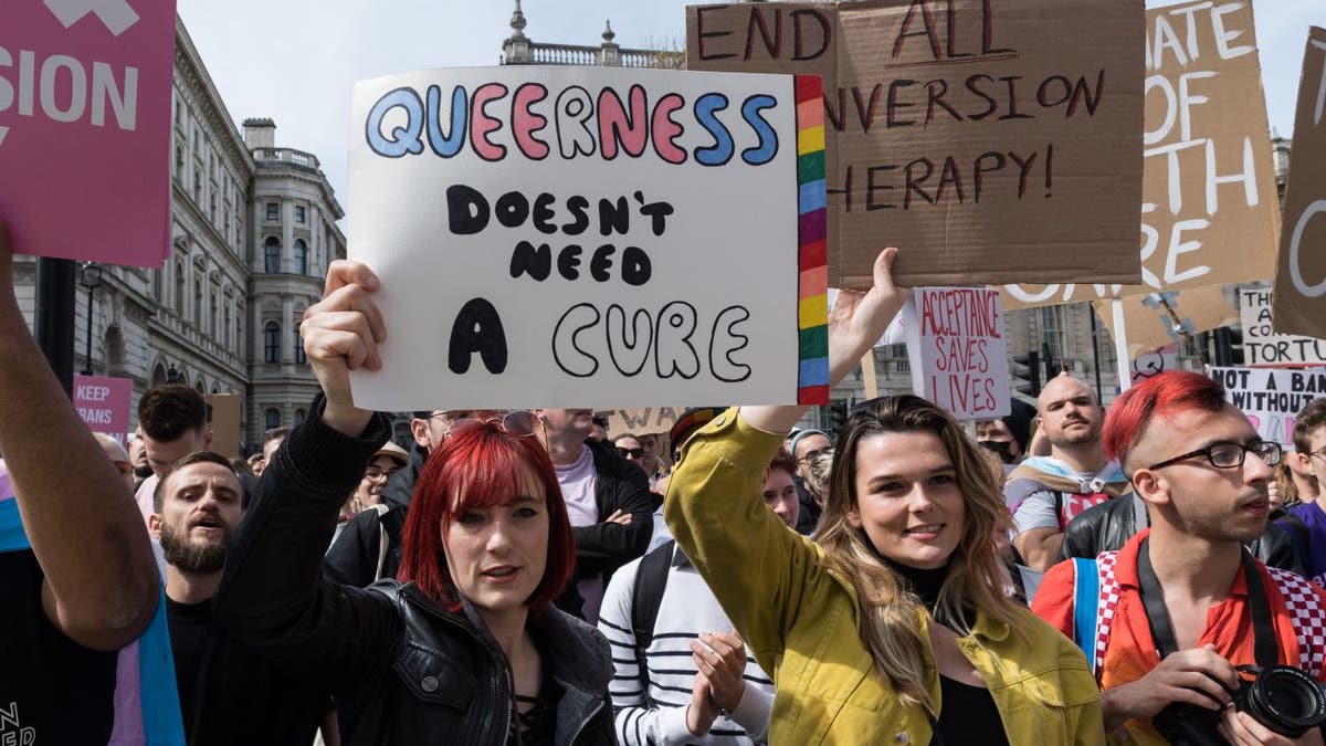 LGBT activists, transgender people and their supporters demonstrate outside Downing Street in a protest the UK governments decision to exclude transgender people in a conversion therapy ban on April 10, 2022, in London, England. (Photo credit should read Wiktor Szymanowicz/Future Publishing via Getty Images)