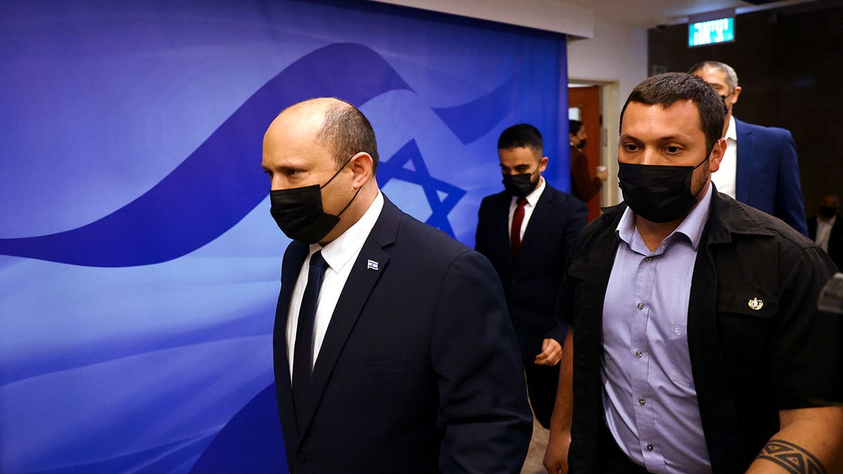 Israeli Prime Minister Naftali Bennett, left, attends a cabinet meeting at the Prime Minister's office in Jerusalem Sunday, April 10, 2022.