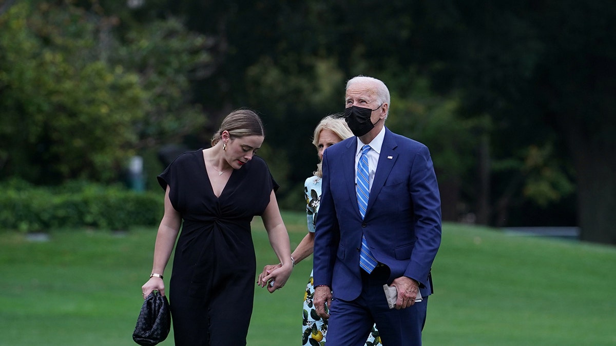 The Bidens walk with their granddaughter, Naomi Biden.