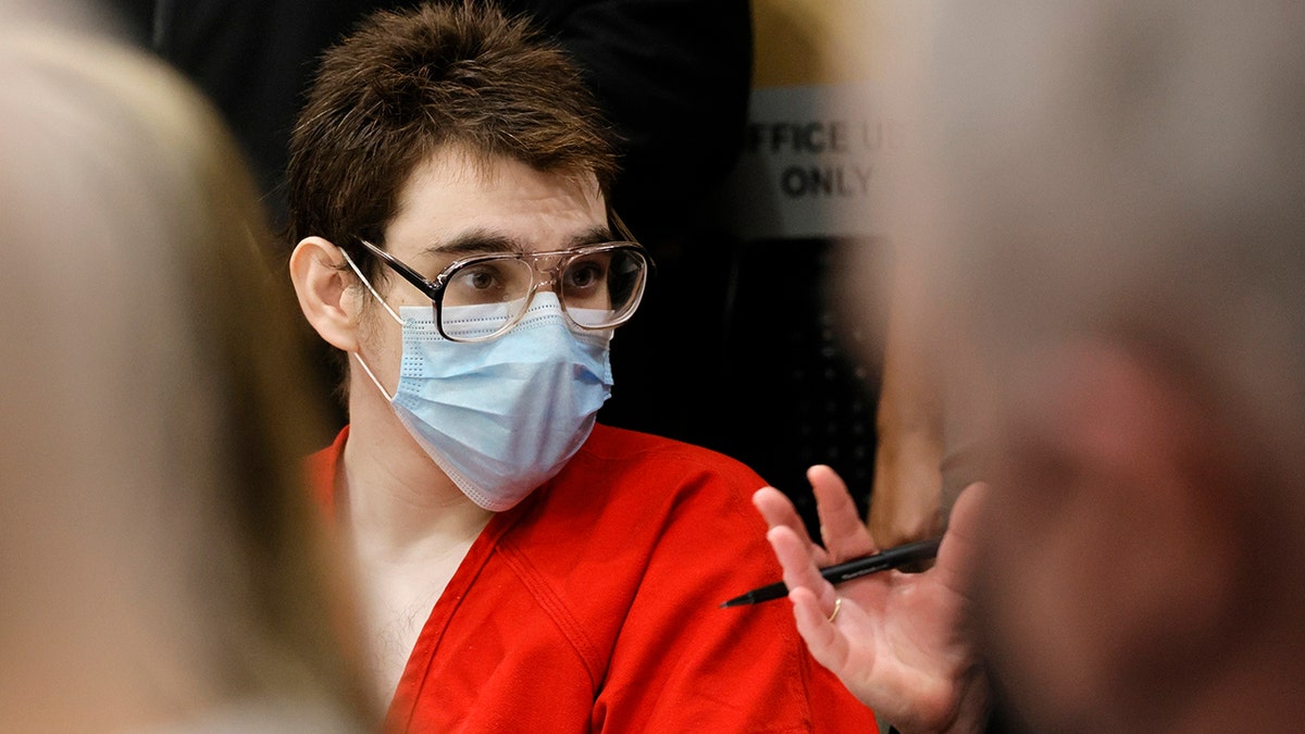 Nikolas Cruz, the Parkland school shooter, appears in court wearing an orange jumpsuit, glasses, and a mask