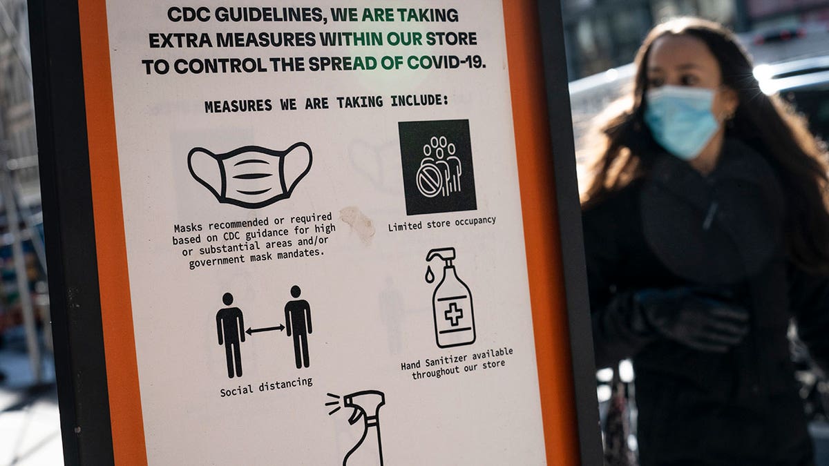 FILE - Pedestrians wearing protective masks walk along Broadway in the SoHo district of New York, Friday, March 4, 2022. (AP Photo/John Minchillo, File)
