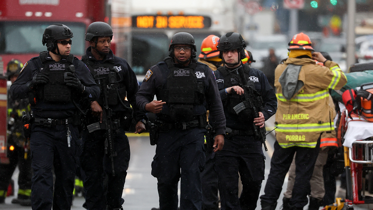 Law enforcement officers work near the scene of a shooting at a subway station in the Brooklyn borough of New York City, New York, U.S., April 12, 2022