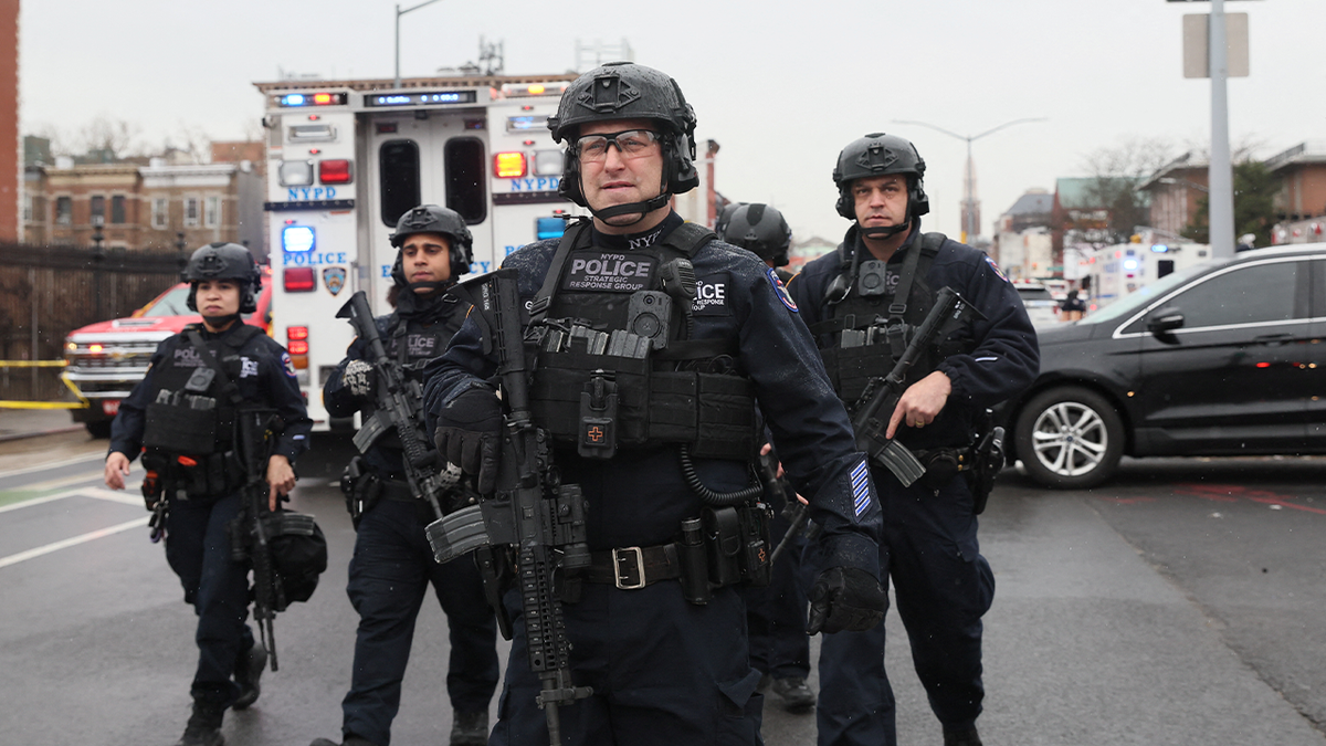 Law enforcement officers work near the scene of a shooting at a subway station in the Brooklyn borough of New York City, New York, U.S., April 12, 2022