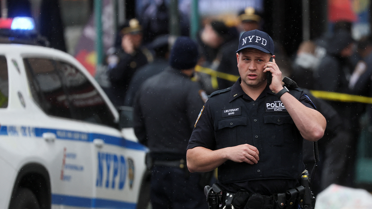 Law enforcement officers work near the scene of a shooting at a subway station in the Brooklyn borough of New York City, New York, U.S., April 12, 2022